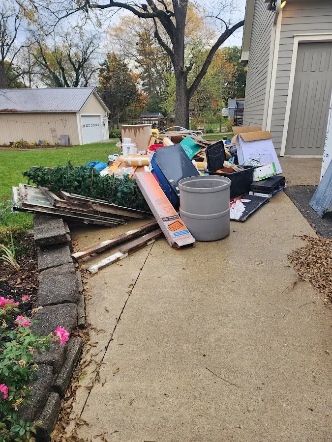 Dumpster being loaded with debris for Roofing Dumpster Rental in Suamico